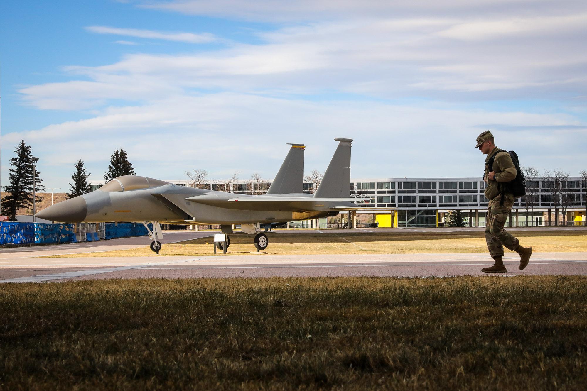 A cadet walks on the grounds of the United States Air Force Academy