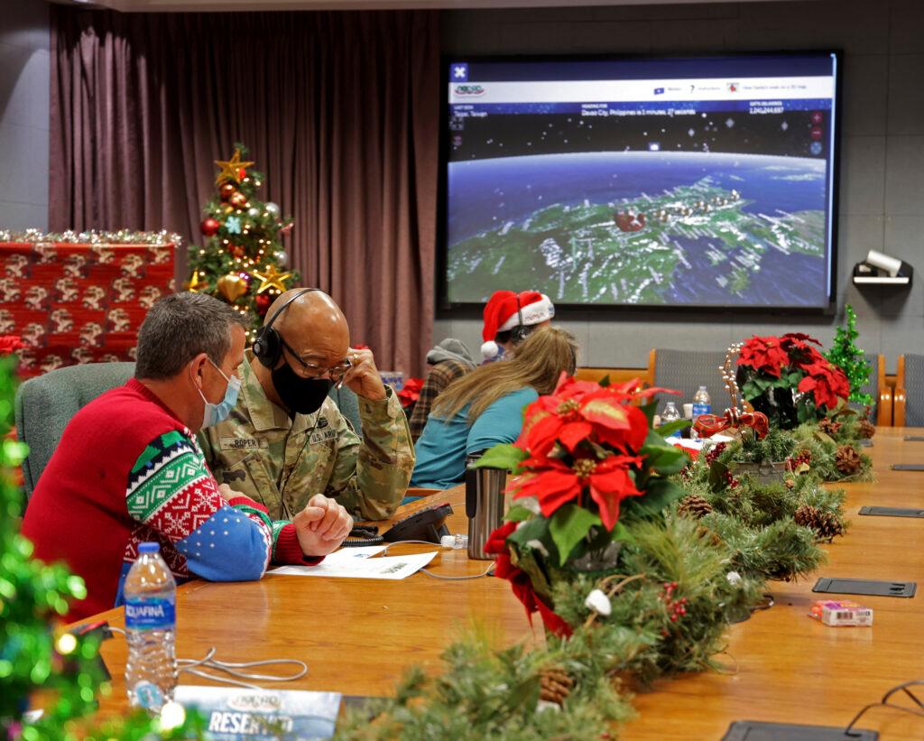 volunteers answering phones and emails from children around the globe during the annual NORAD Tracks Santa event on Peterson Air Force Base