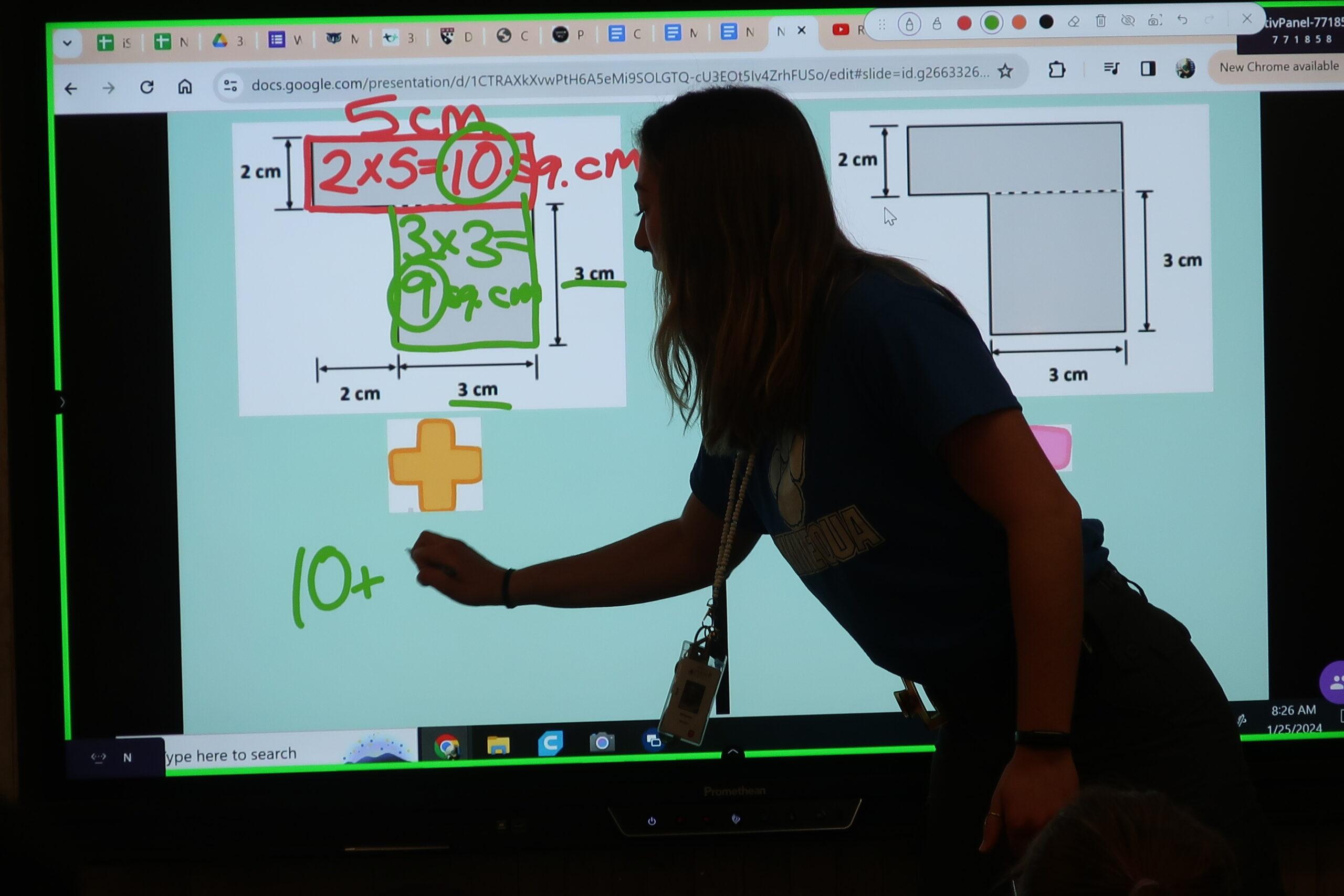 Teacher works through math problem