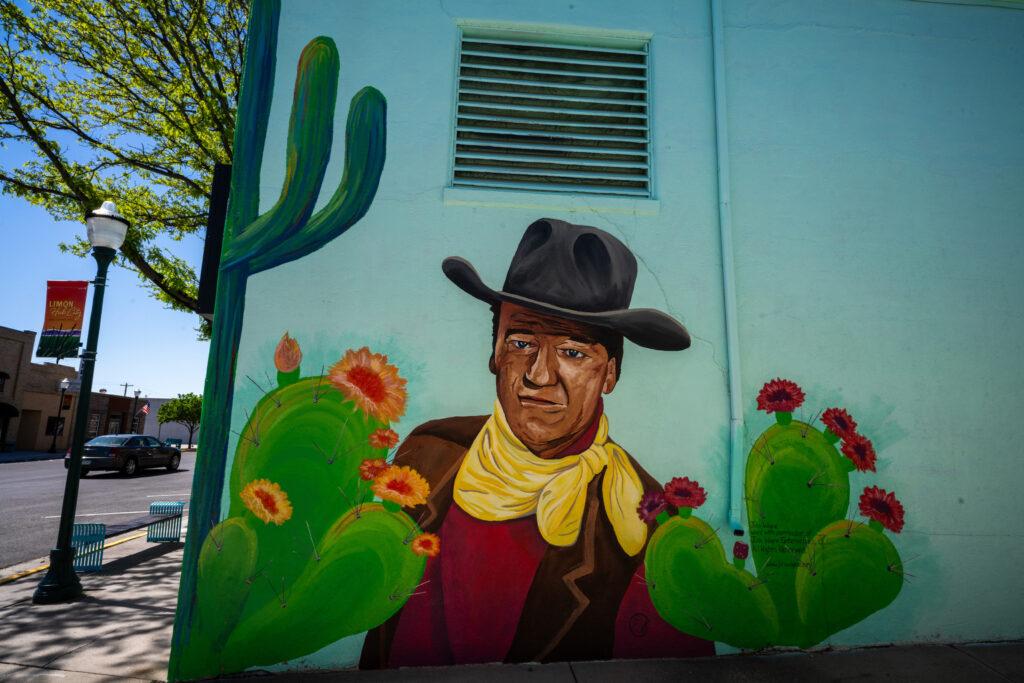 MURAL PAINTING OF ACTOR JOHN WAYNE WITH A COWBOY HAT
