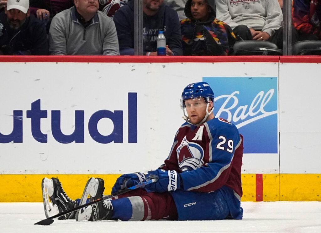 Colorado Avalanche center Nathan MacKinnon sits on the ice, moments after the Dallas Stars scored their game -winning goal.