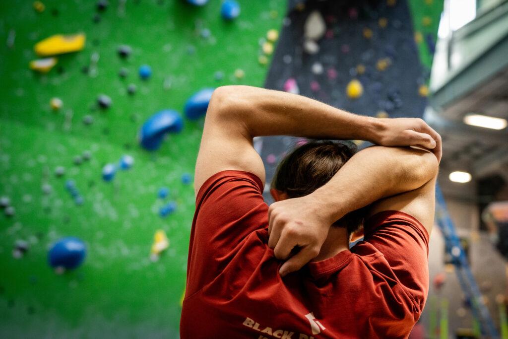 Colin Duffy stretches at The Spot climbing gym