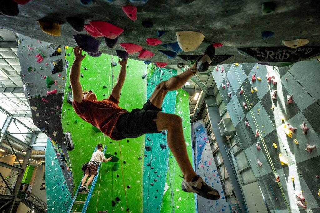 Colin Duffy practices climbing hanging upside down