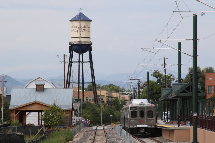 The historic Olde Town Arvada water tower above the much newer RTD line through the Denver suburb