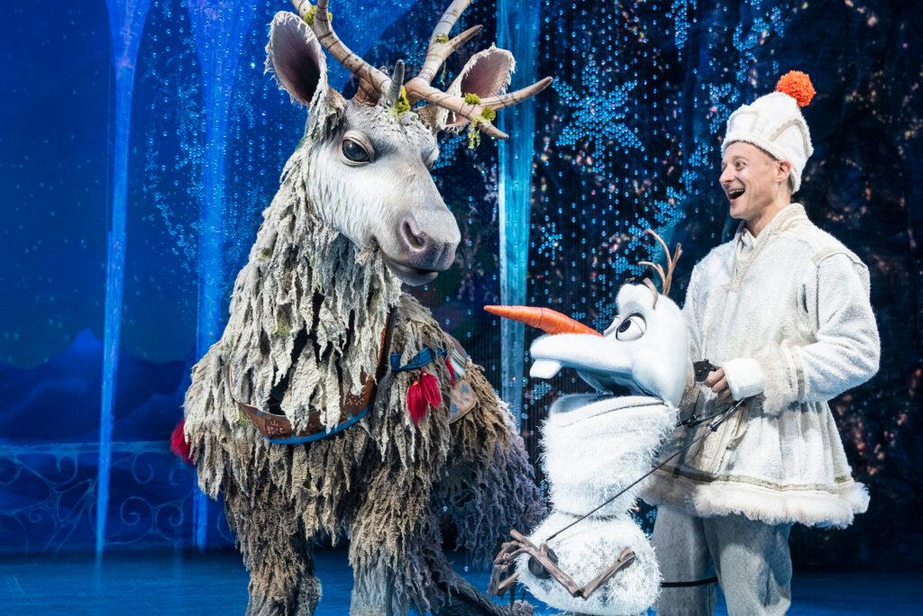Collin Bajaas Sven and Jeremy Davis as Olaf pose with a reindeer in the Frozen North American Tour.