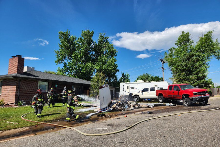 A photo shows a plane crashed in front of an Arvada home. The truck in the driveway looks to have sustained damage. Firefighters were putting out a fire.