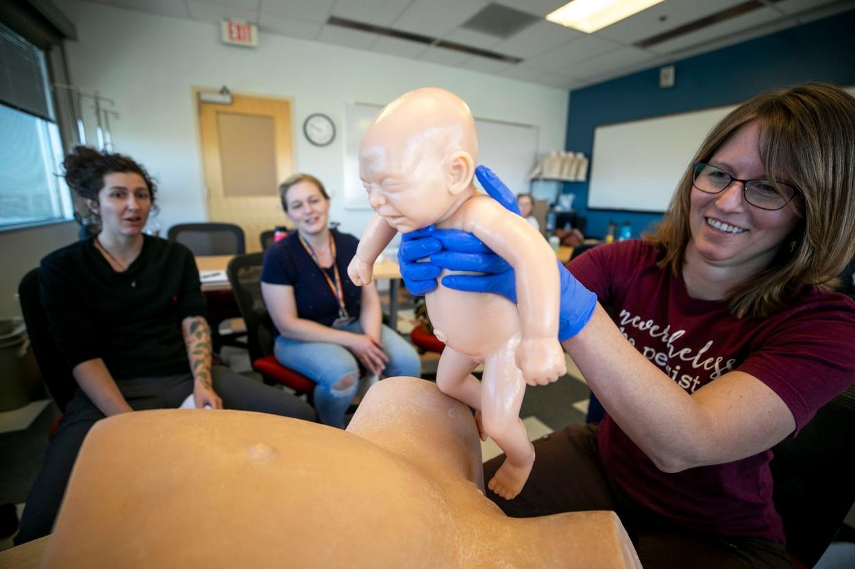 Tessa Huizenga practices delivering a baby during class in University of Colorado College of Nursing’s midwifery program. June 6, 2024.
