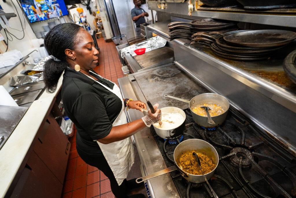 AFRICAN GRILL AND BAR CO-OWNER THEODORA OSEI-FORDWUO IN THE KITCHEN