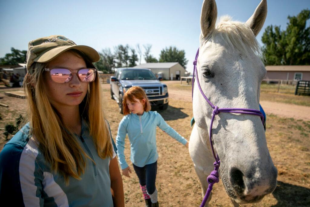 two girls, a horse, a truck and a ranch.