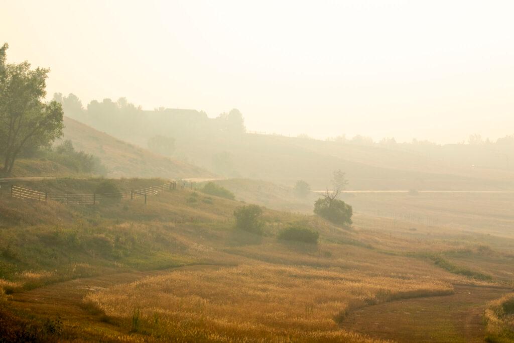 Smoke from the Quarry fire hangs over Deer Creek Canyon Road in Jefferson County