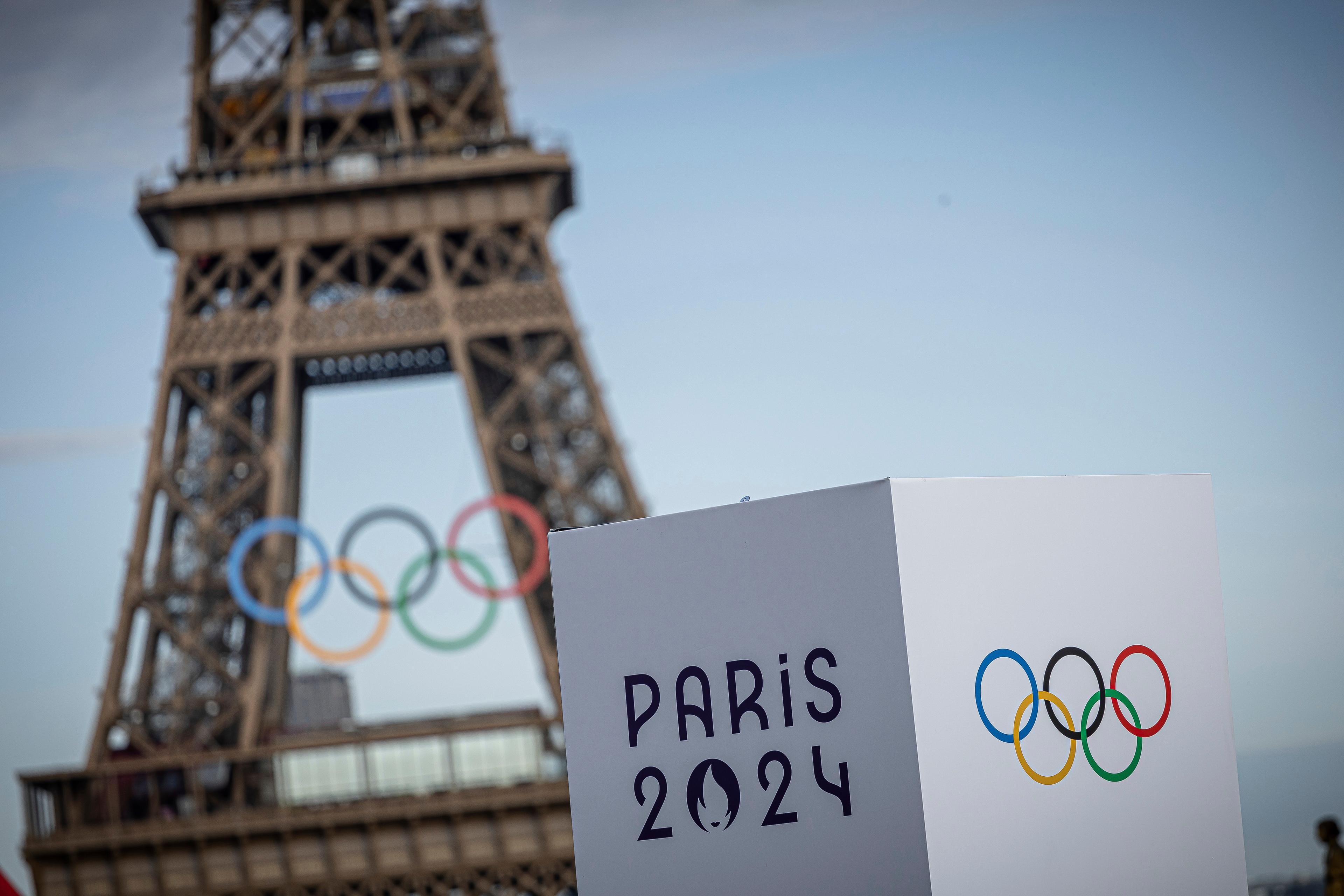 OLY Paris Olympic Rings in front of the Eiffel Tower.