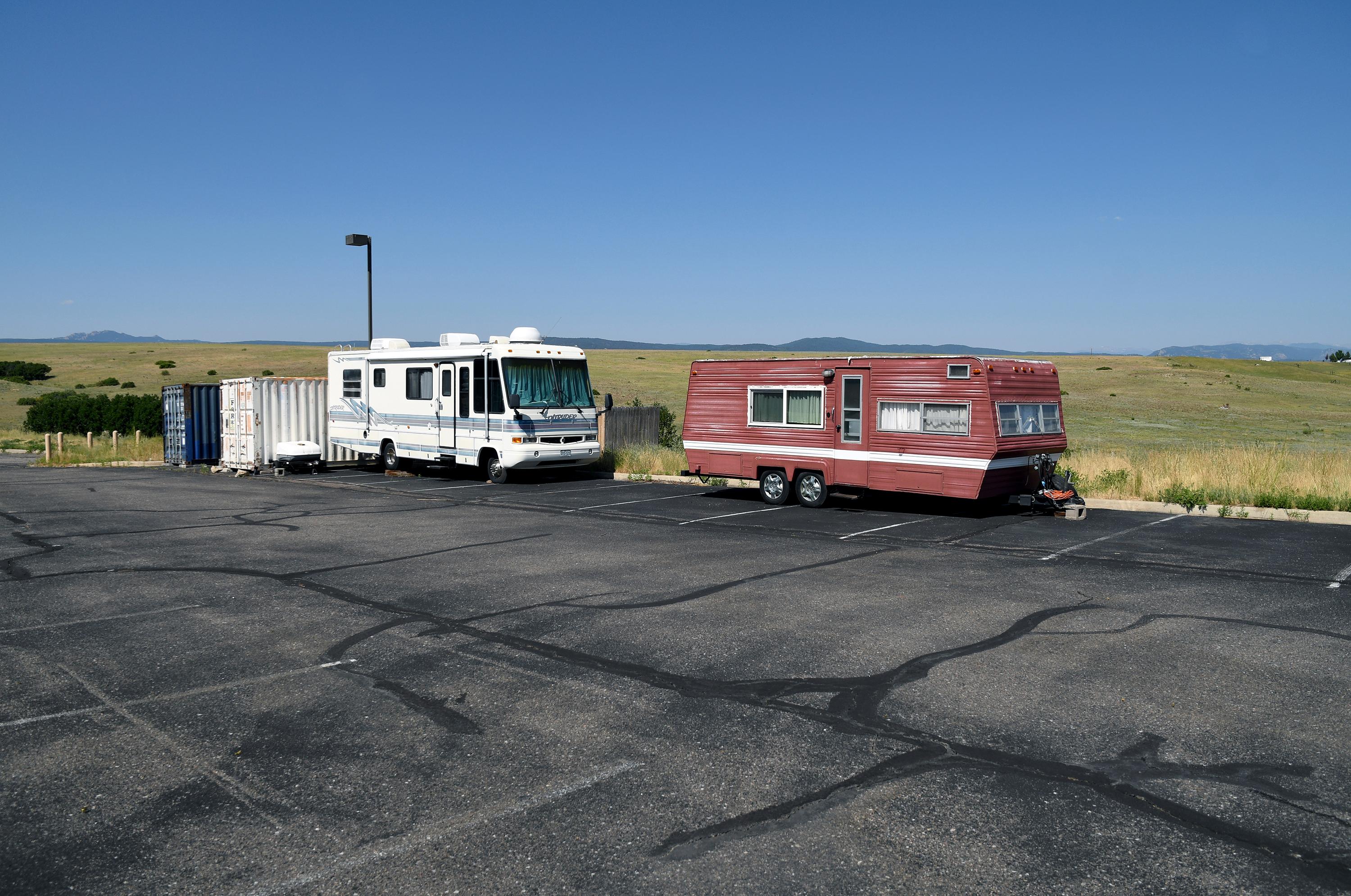 A recreational vehicle and camping trailer sit empty in The Rock church's parking lot in Castle Rock.