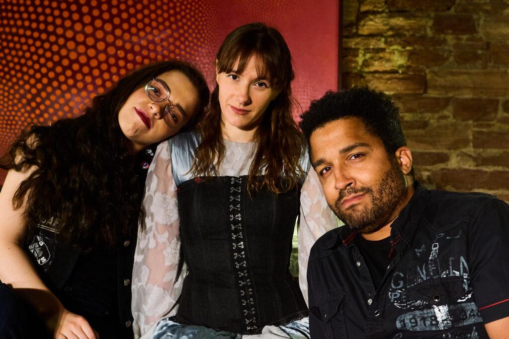 three of the actors from Gin and Gothic pose looking straight into the camera.