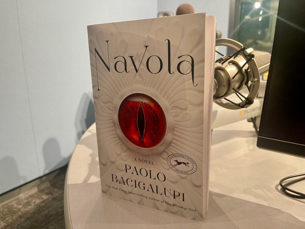 A copy of &quot;Navola&quot; sits in the Colorado Matters studio. The cover features a red dragon eye.