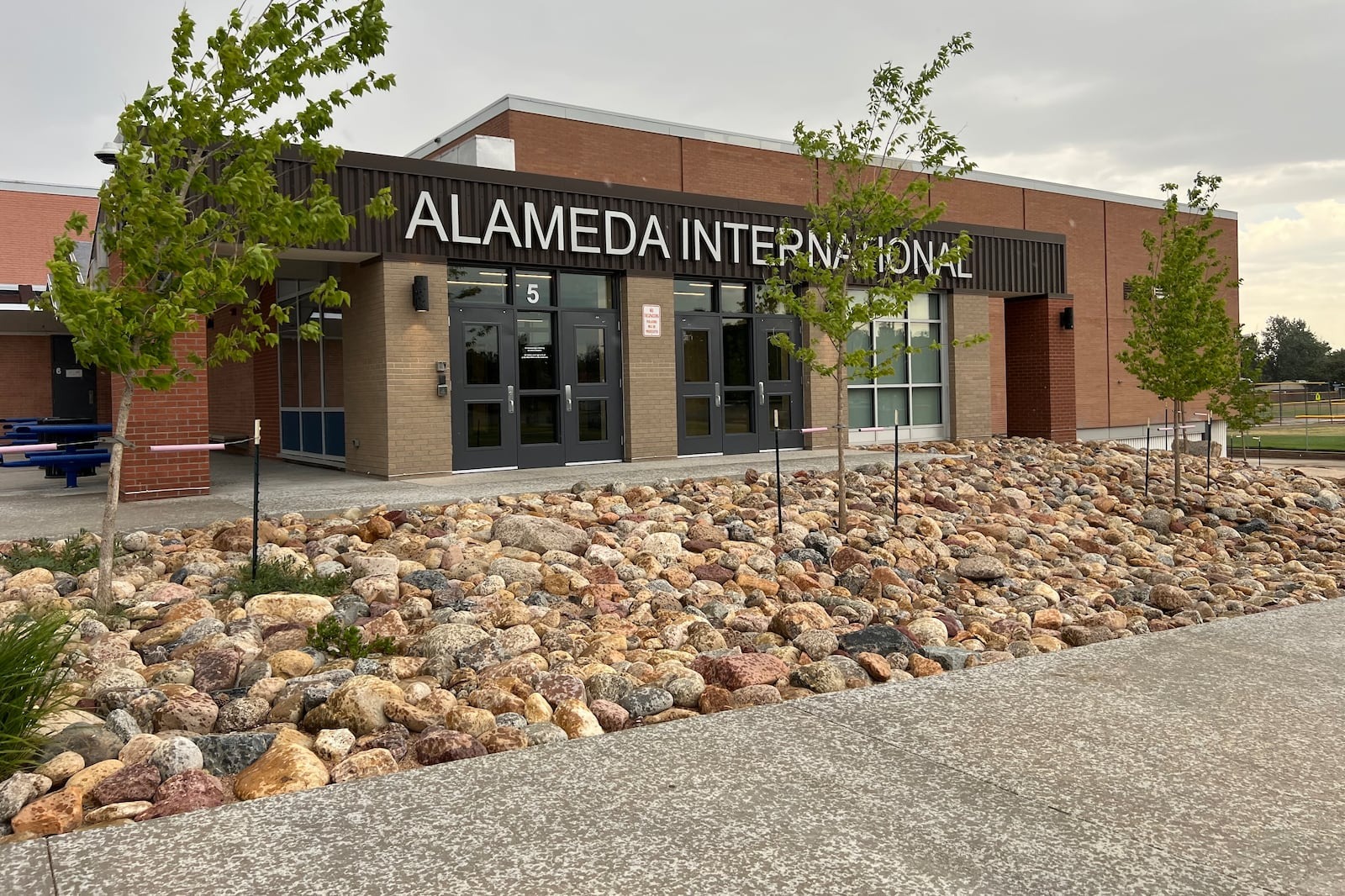 The front of a school building with the sign Alameda International on the front.
