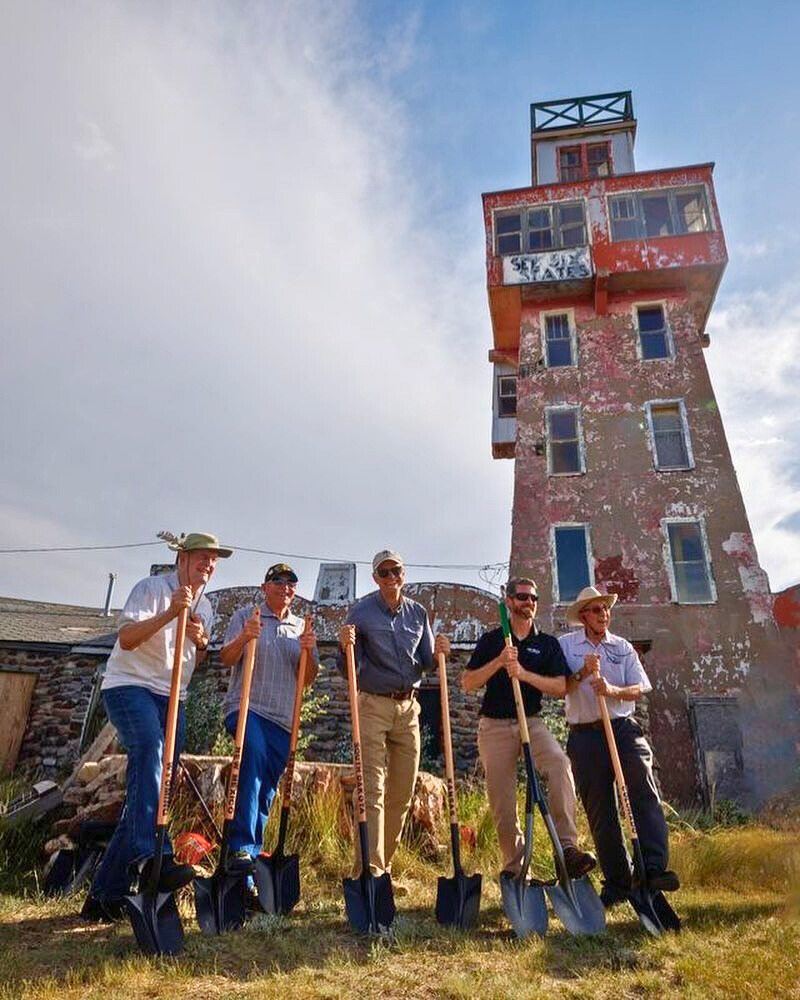 Five members of the Ghost Town Club of Colorado pose with shovels in front of the World Wonder View Tower for the renovation groundbreaking on July 4, 2024.