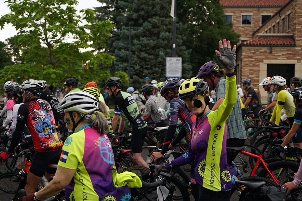 A large group of cyclists in colorful gear.