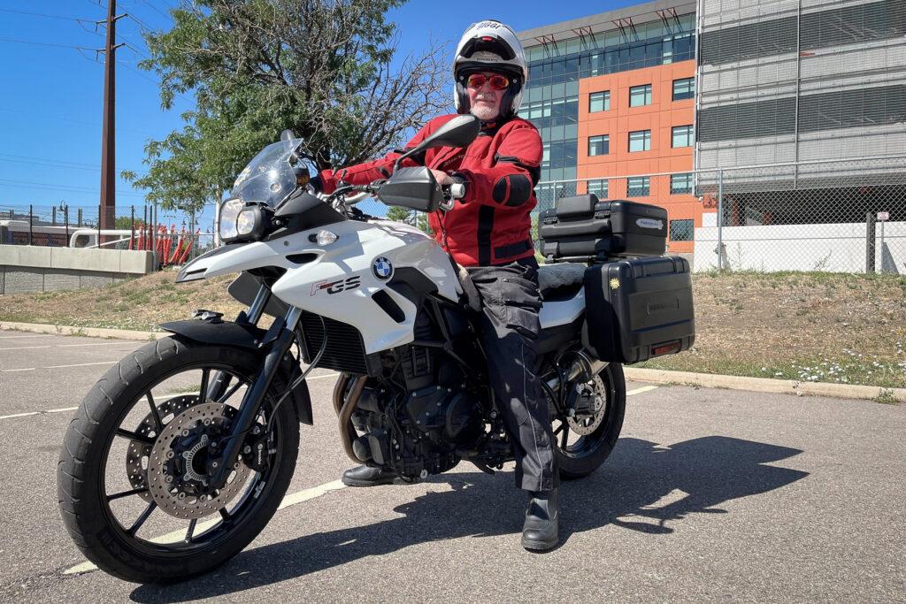 Siggi Pflumm on his BMW motorcycle stands outside the Colorado Department of Transportation’s headquarters in Denver