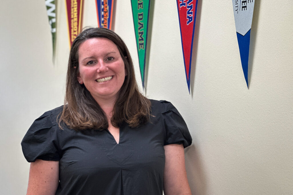 A principal stands in her school.