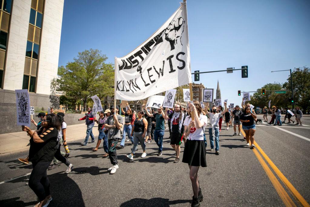 Protesters march down Colfax Avenue during a rally for Kilyn Lewis,