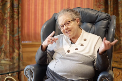 Sherie Simonsen, 65, sits in a chair in her Denver home. She received free mental health counseling sessions from the Colorado Gerontological Society to help her cope with grief after her mother’s death.