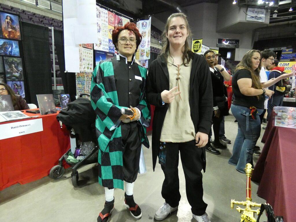 Two teenagers wear anime-inspired costumes