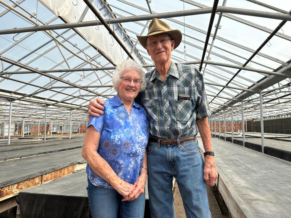 Jerol and Kathy Novacek pose for a photo in Novacek's Greenhouse in Golden.