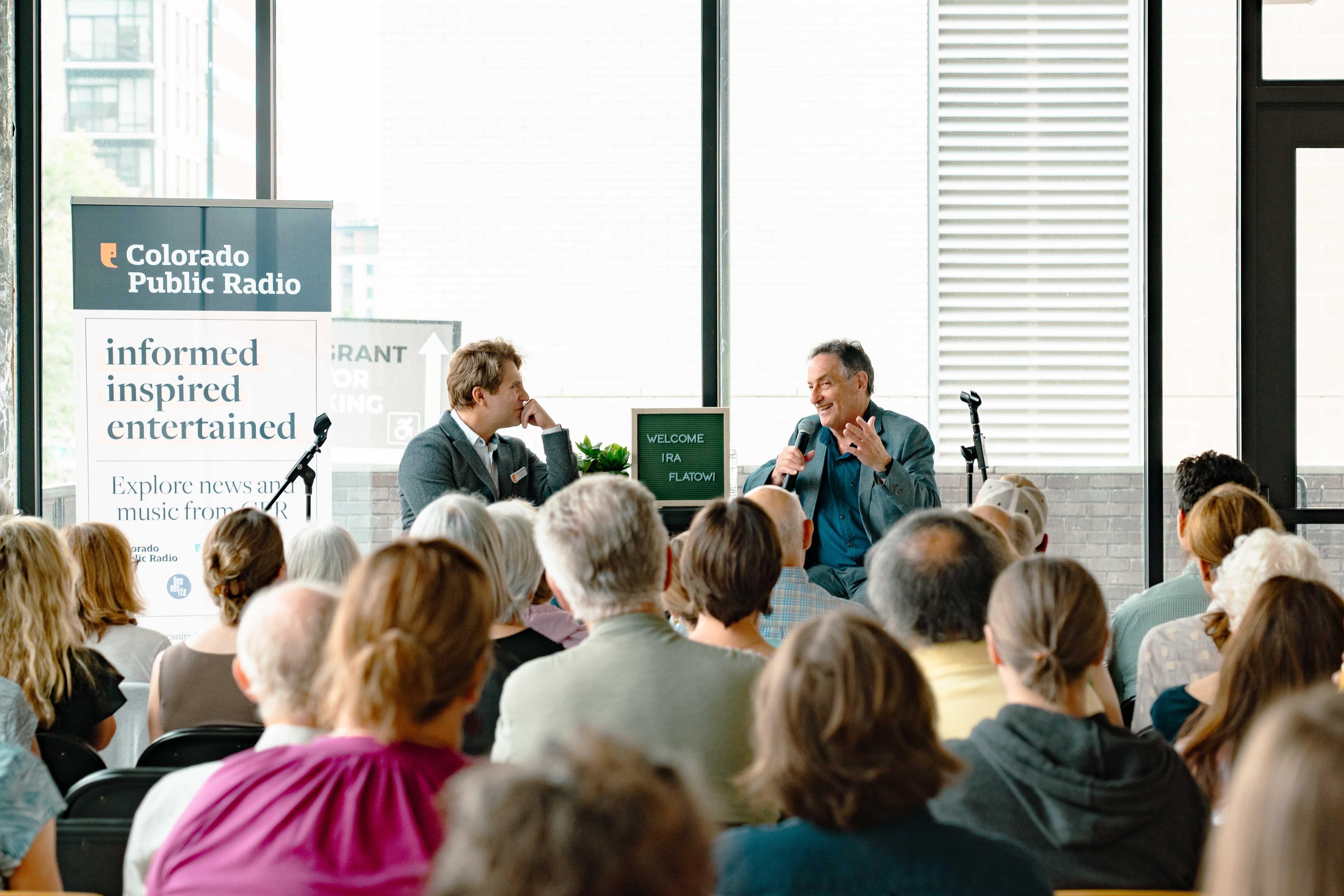 An audience listens to a conversation between Science Friday host Ira Flatow and CPR Southern Colorado reporter Dan Boyce at CPR News.