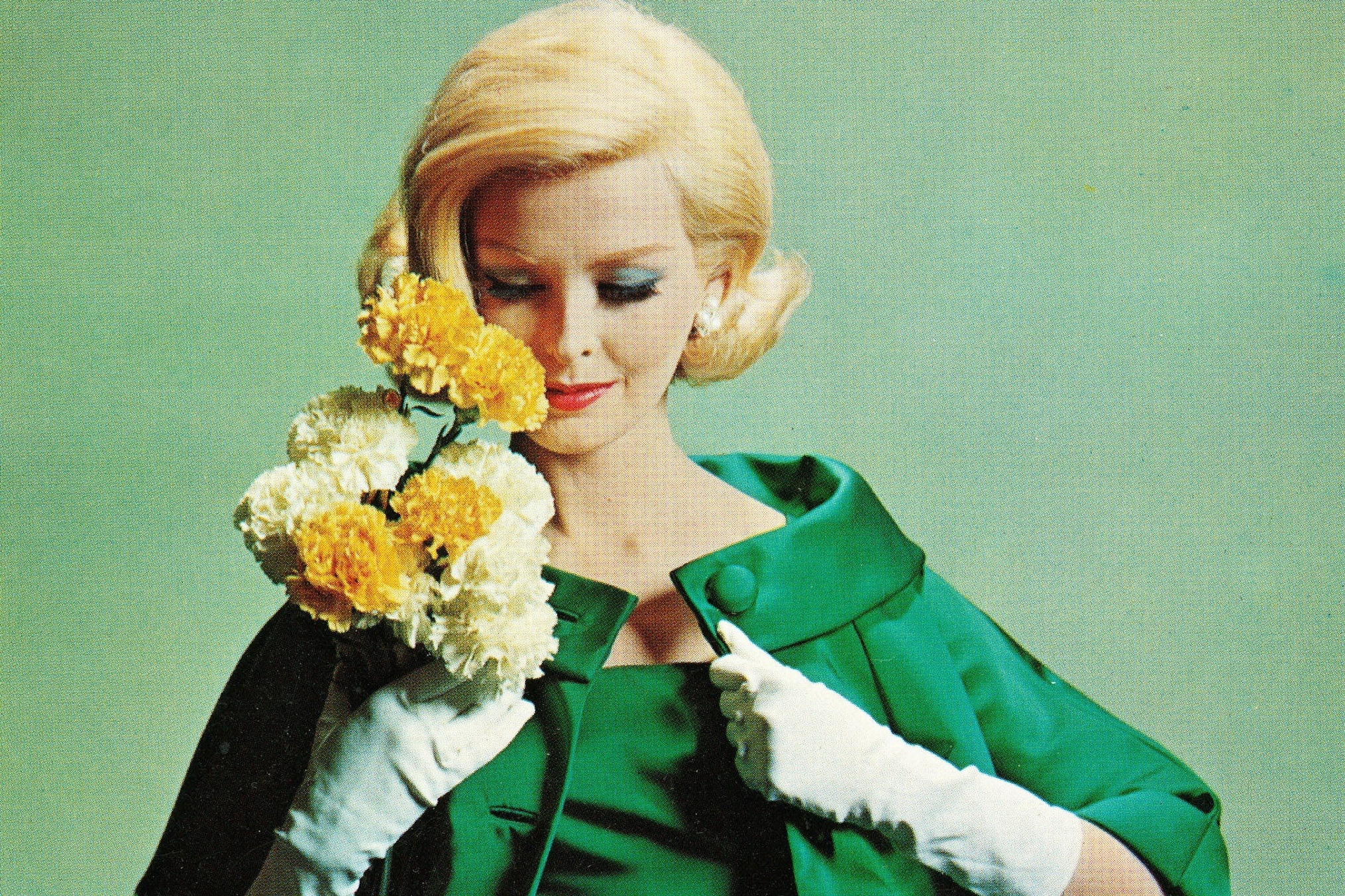 A model holds Colorado carnations in a Vogue ad.