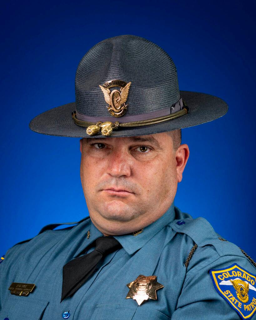 Man in police uniform looking directly at camera unsmiling