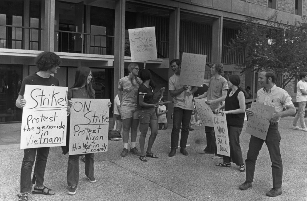 CU students hold signs: &quot;Strike! protest the genocide in Vietnam,&quot; &quot;On strike protest Nixon and his war in insanity,&quot; &quot;On Strike no more war,&quot; &quot;Stop the atrocities in Asia and on campus on strike,&quot; &quot;On strike for peace,&quot; &quot;End the war shut it down,&quot; &quot;Shut it down for your own sake.&quot;