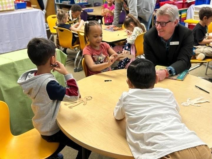 The new president of the Colorado Education Association, Kevin Vick, speaks with a group of students.