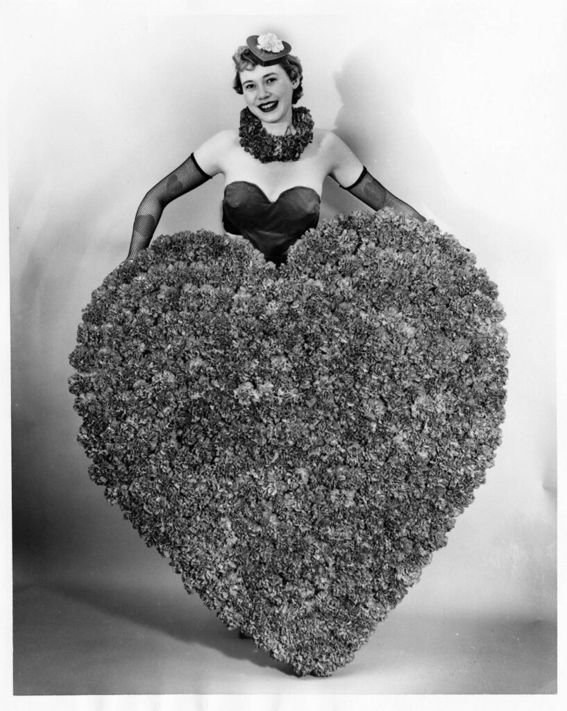 Miss Colorado Carnation for 1954 displays the giant valentine heart of Colorado carnations.
