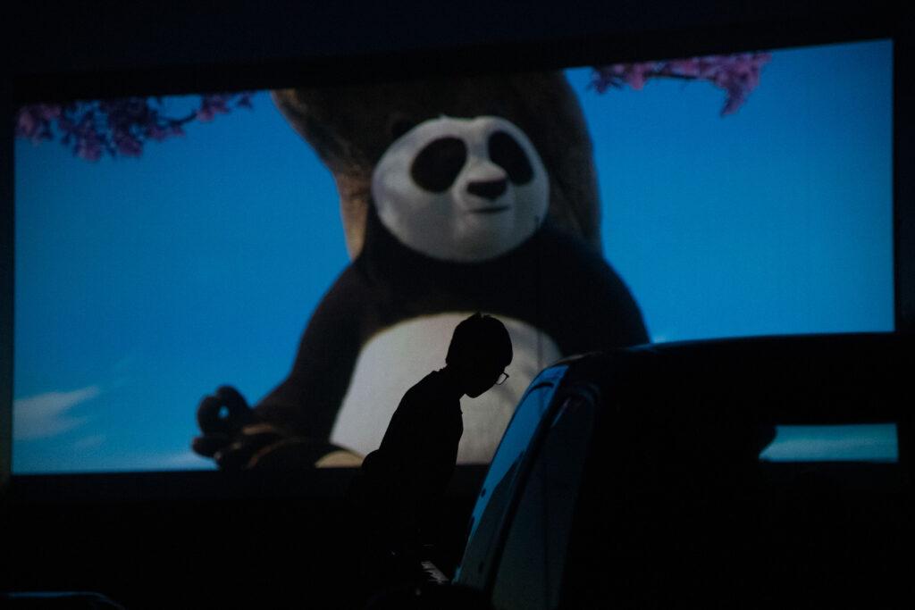 A young child watches a Kung Fu Panda movie