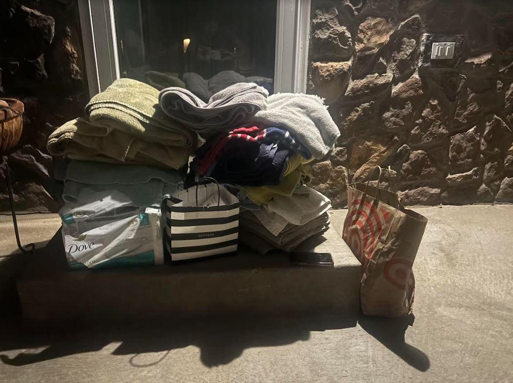 A mound of donated towels and soap sits outside the home of Lyons' town administrator.