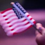 New US citizen Stella Belony, of Haiti, waves an American flag.