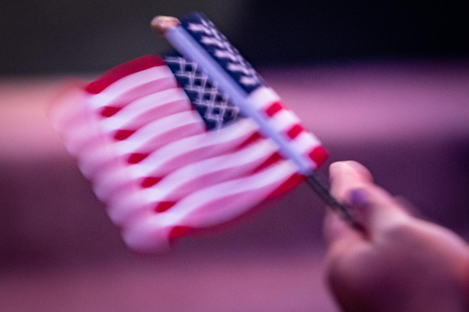 New US citizen Stella Belony, of Haiti, waves an American flag.