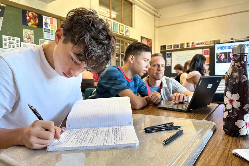 A student writes in a notebook.