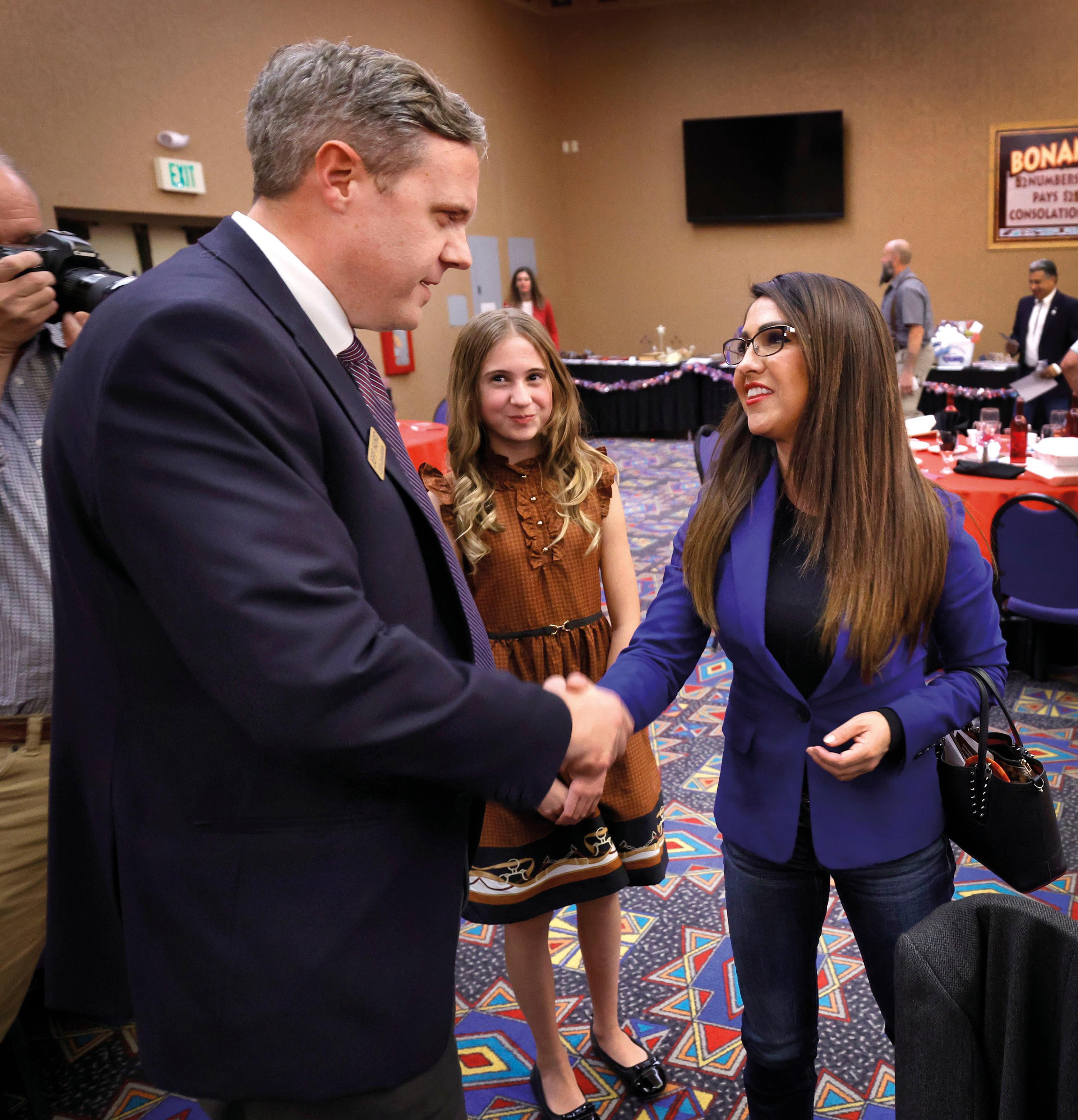 A man and a woman shake hands