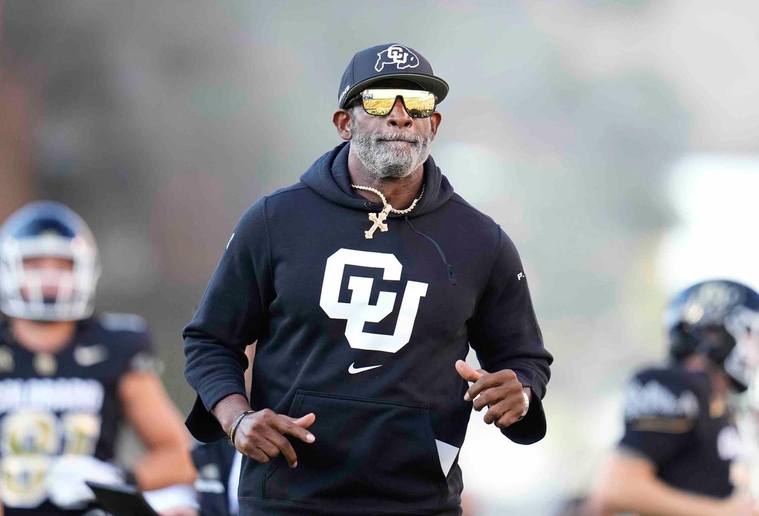 Colorado head coach Deion Sanders takes the field