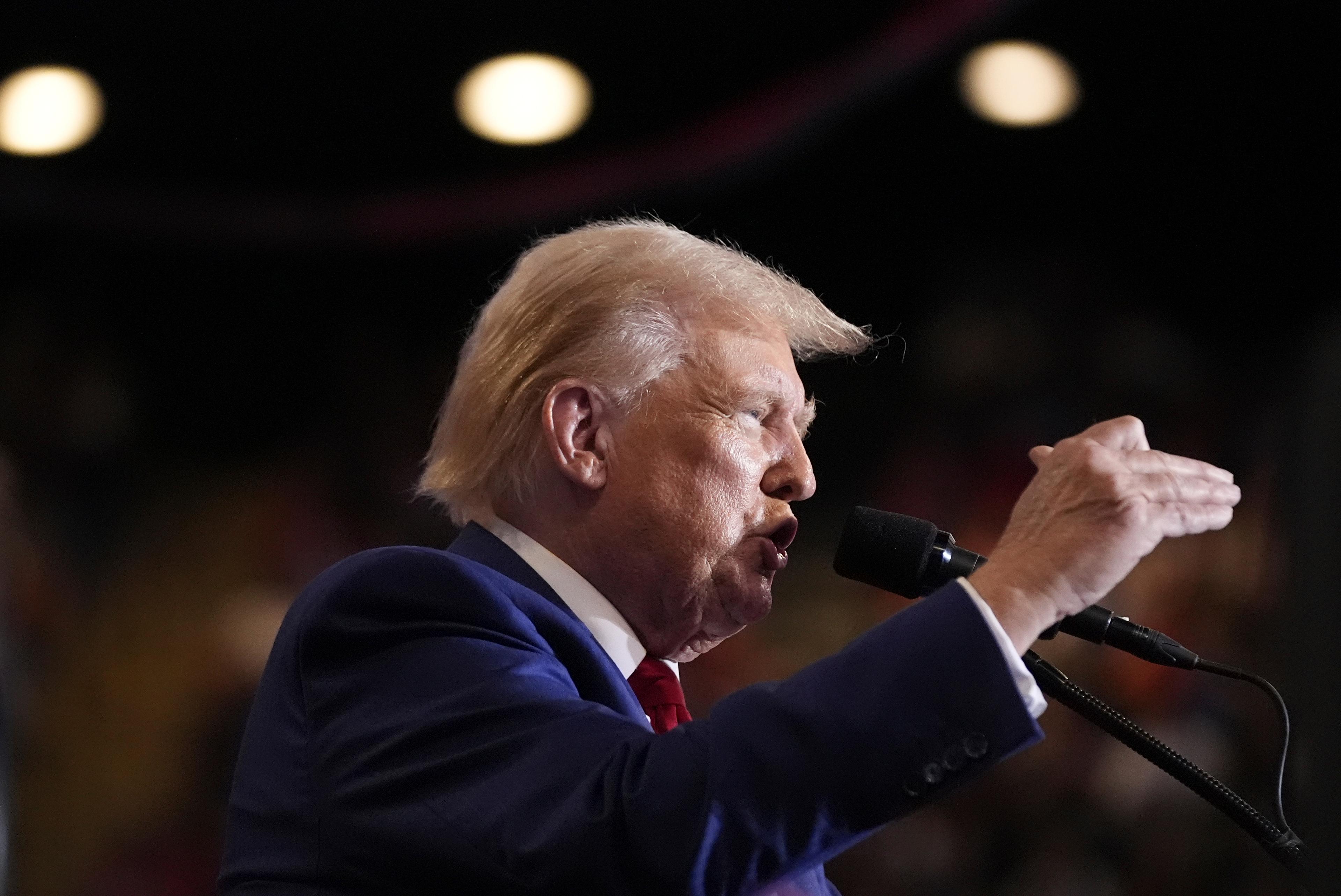 Republican presidential nominee and former President Donald Trump gestures from the podium at a campaign stop in Uniondale, New York.