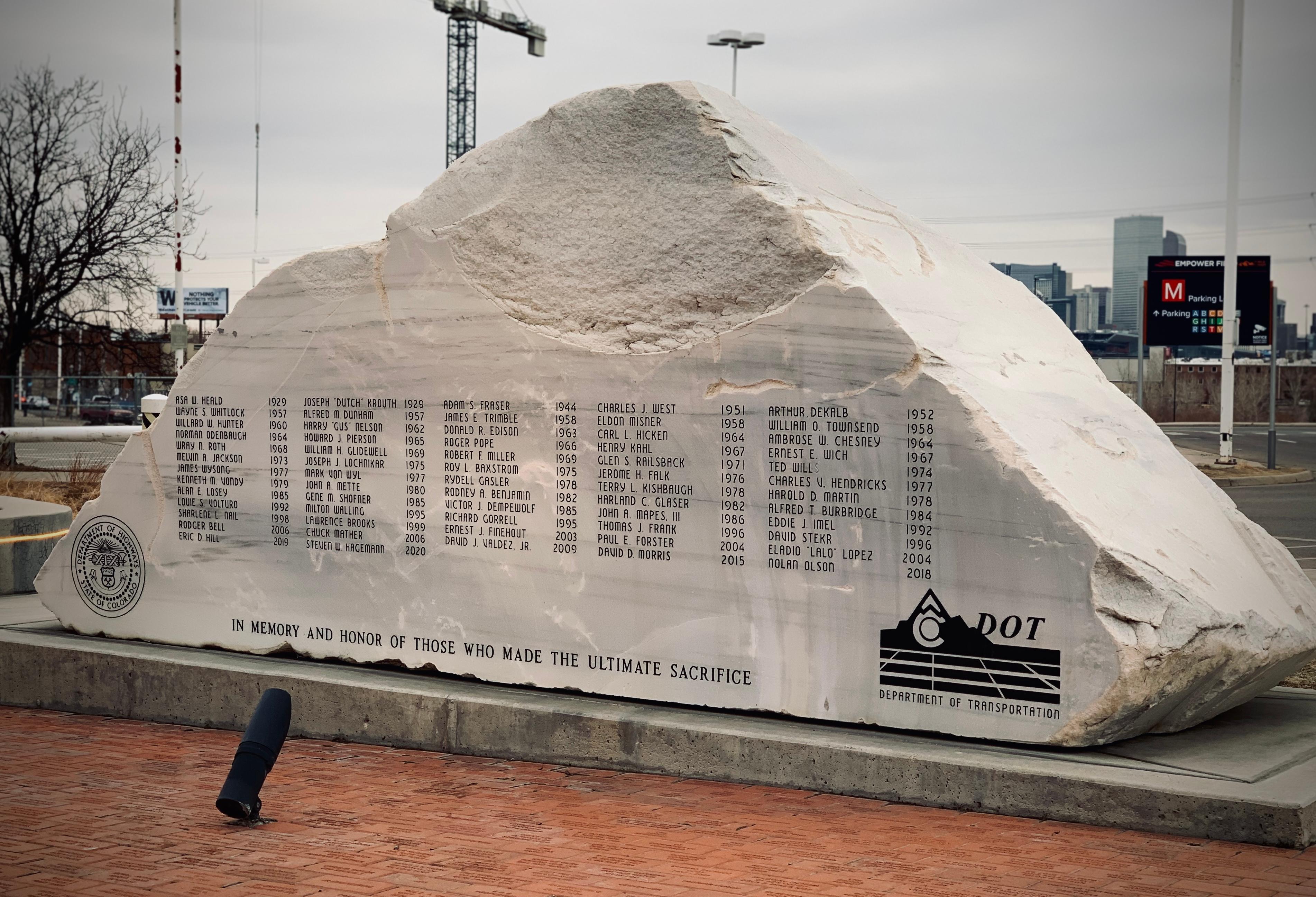 A rock memorial with names of CDOT employees killed on the job.