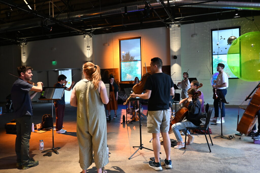 Musicians with Sphere Ensemble gather for rehearsal