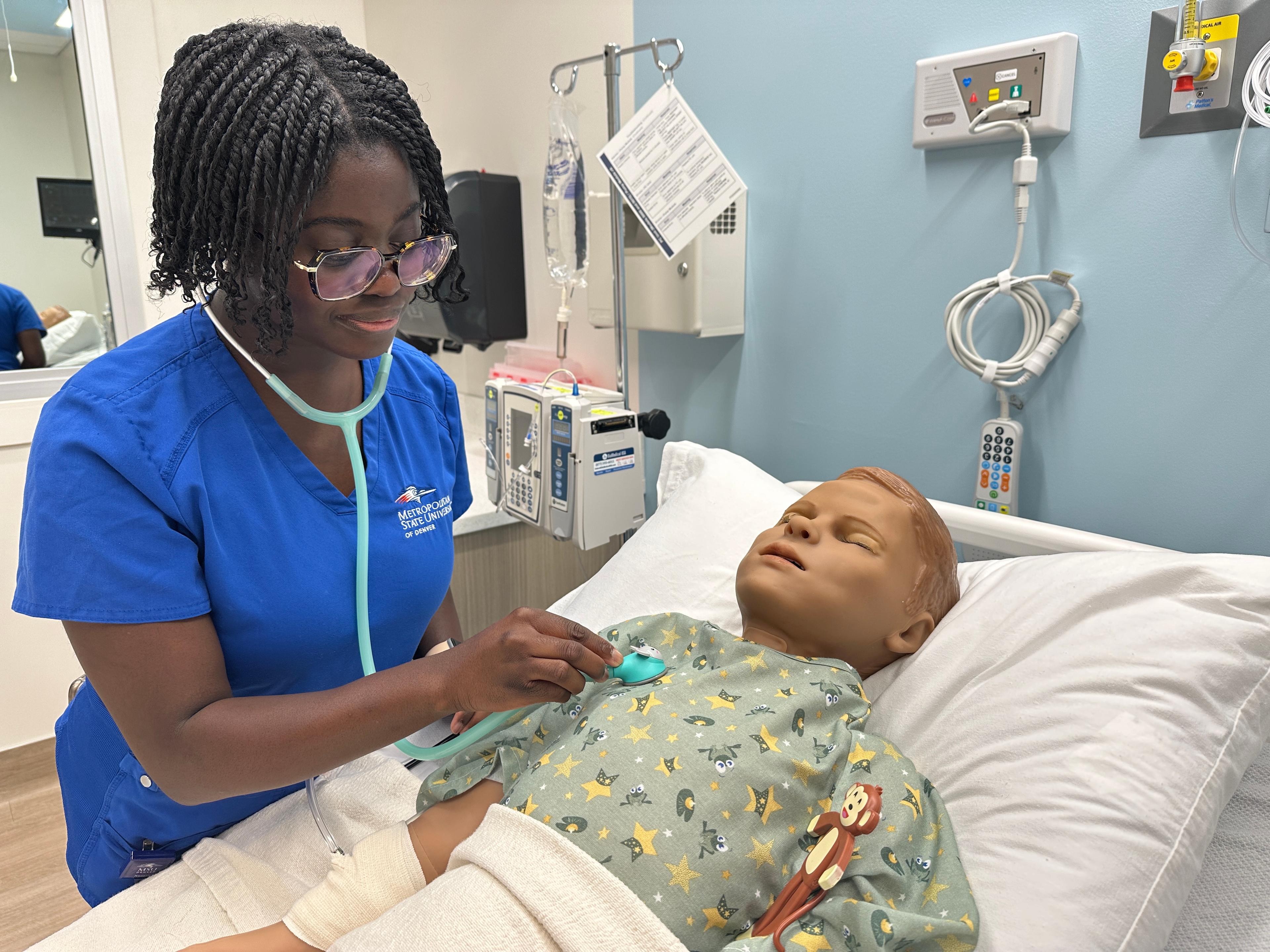 A nursing student monitors heart rate.