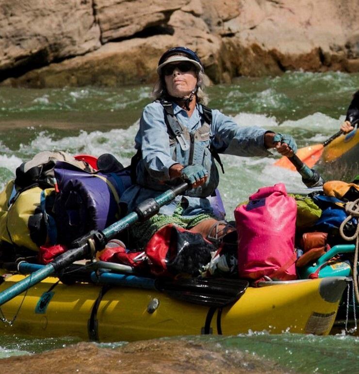 A woman named Martha Hut is seen rowing her raft on the Colorado River.