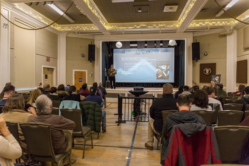 An audience takes in a presentation from the stage of an auditorium during a screening at the 2023 Short Cuts Film Festival