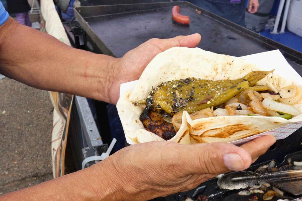 Two hands hold a plate of food