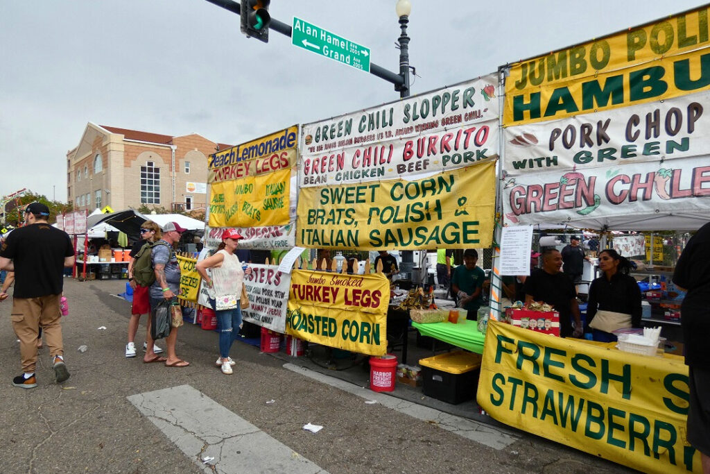 Booths with signs selling fair food