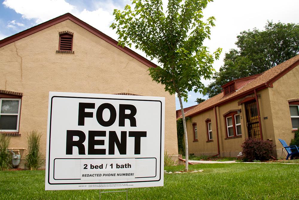 Photo shows a "For Rent" sign outside homes in Denver's Washington Park neighborhood.