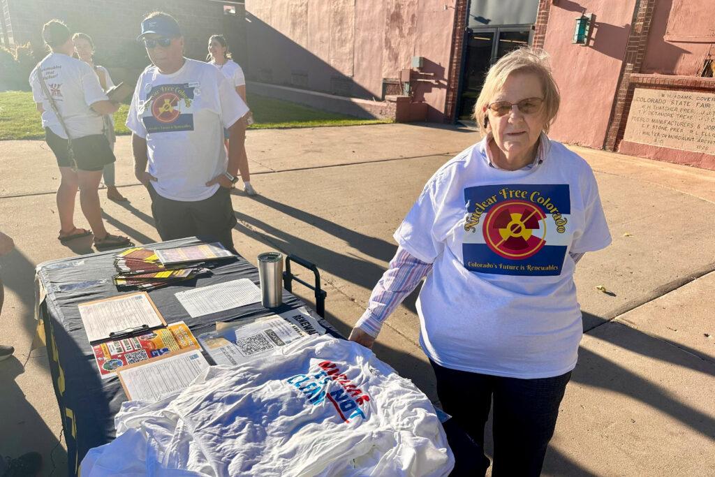 Velma Campbell staffs a table for the Coalition for a Nuclear Free Colorado